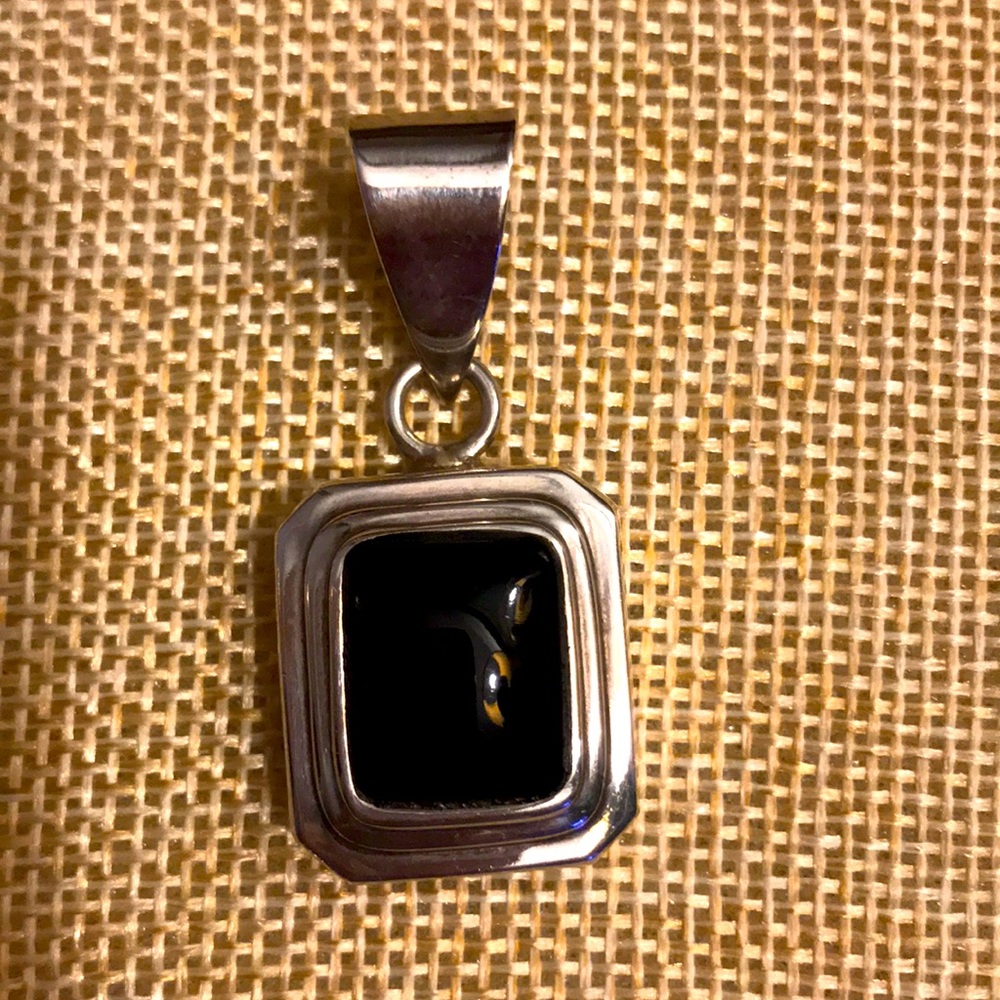 Sterling silver pendant with black stone.